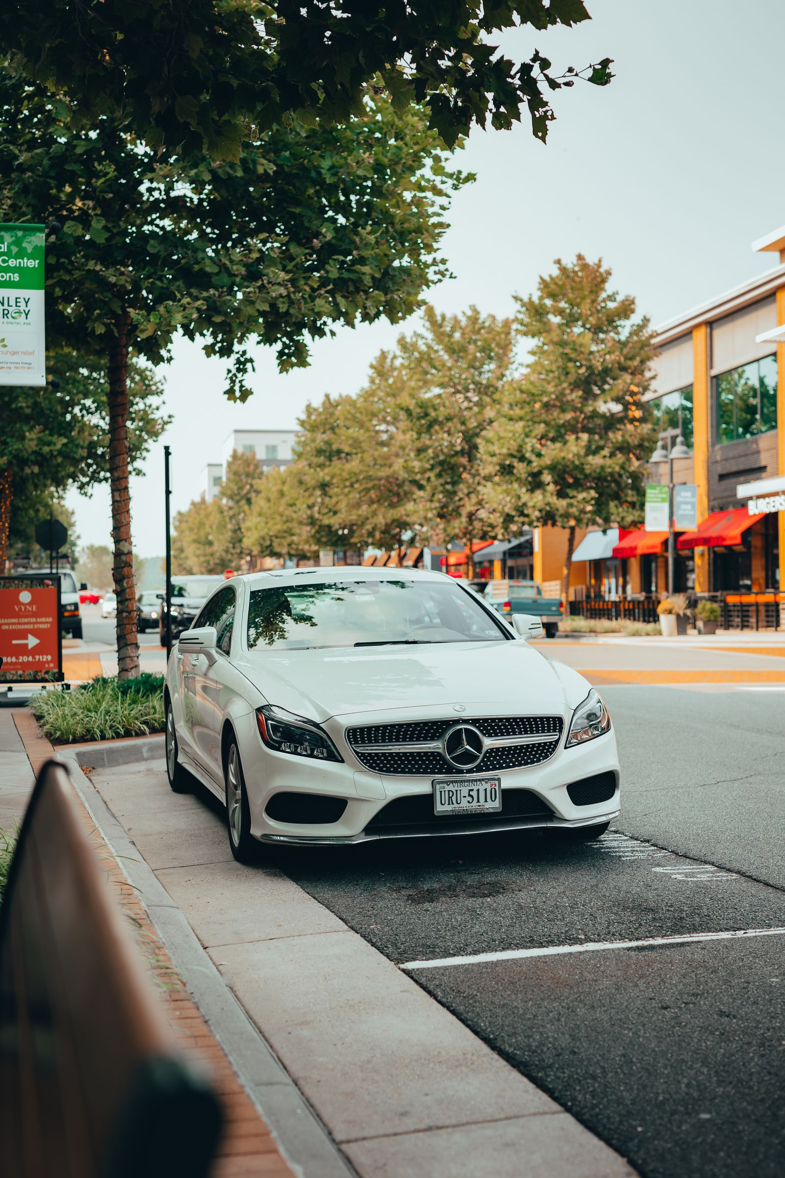 White Mercedes luxury car on a city street