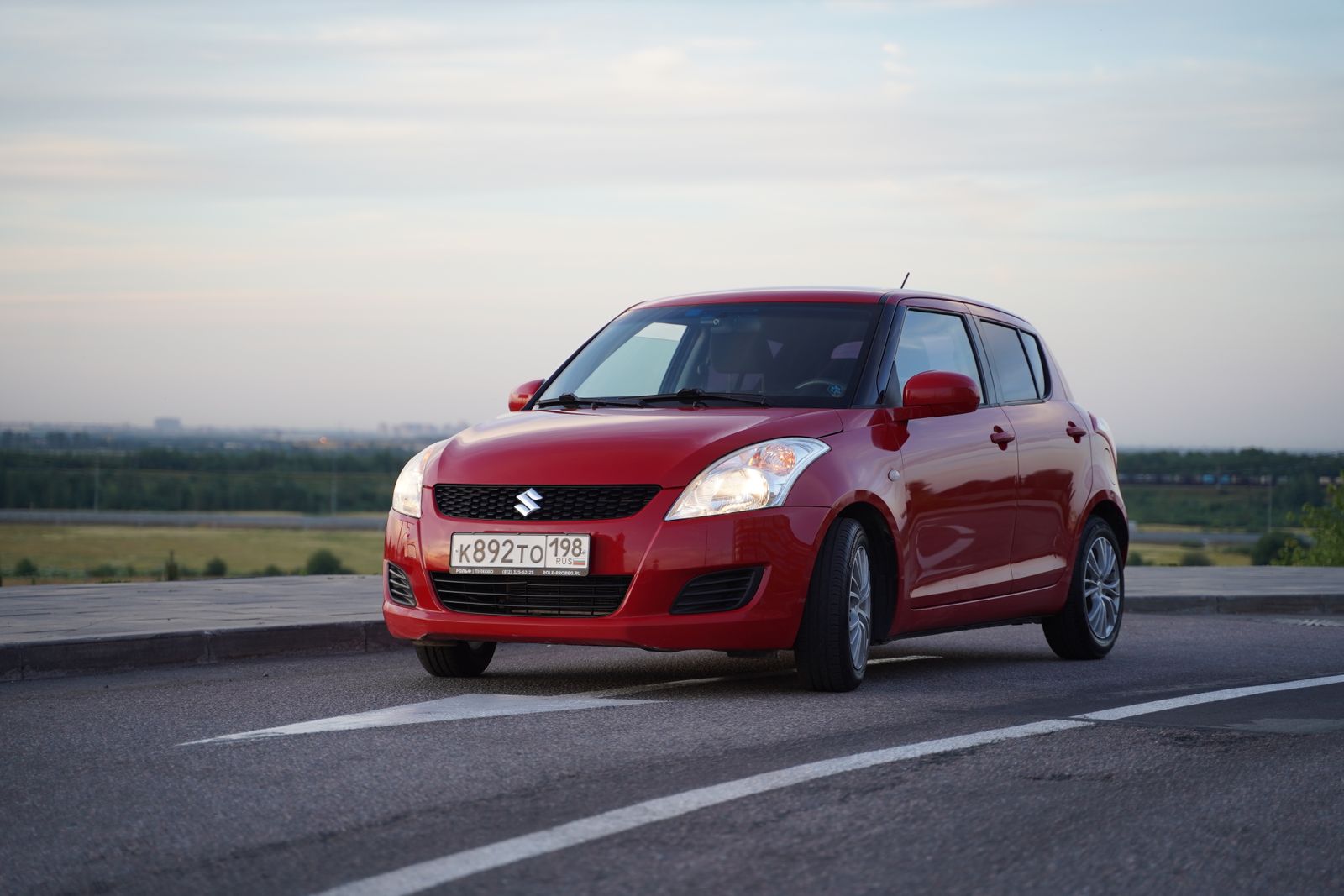 Red Suzuki hatchback car